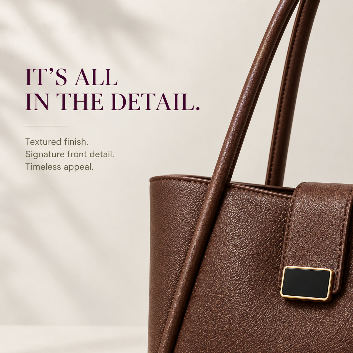 Close-up of textured brown leather Chapter Tote with gold buckle   